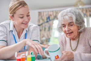 Senior Woman receiving In-Home Occupational Therapy from a female therapist